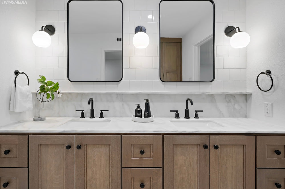 Bathroom vanity with layered stone and cabinetry finishes